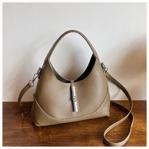 Elegant women's leather hobo shoulder bag with piston lock closure, versatile crossbody bag.