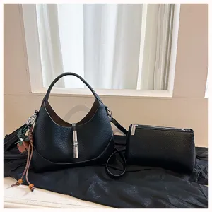 Black hobo shoulder bag set with metal lock closure and small pouch for women daily wear.