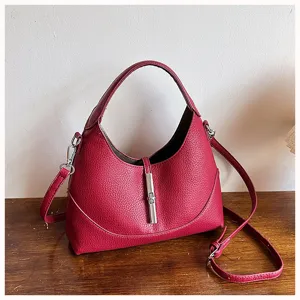 Red leather hobo shoulder bag with metal lock closure and detachable strap for women.