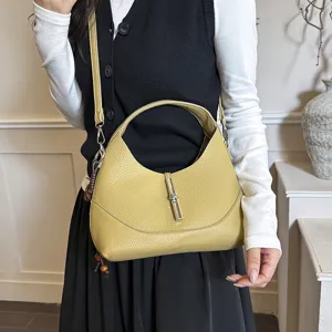 Chic yellow hobo dumpling bag with metal lock closure, versatile shoulder and crossbody style.
