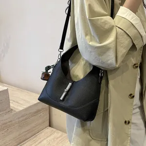 Elegant black leather shoulder bag with metal lock detail, perfect for everyday chic style.