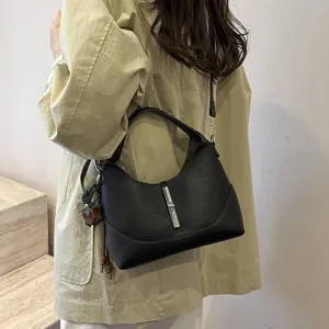 Detailed view of the stylish black hobo dumpling shoulder bag with metallic lock accent.
