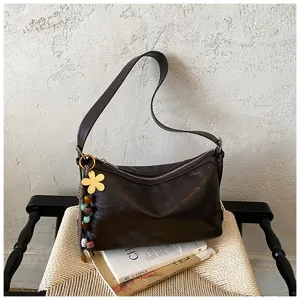 Dark brown leather shoulder bag detail, large capacity hobo bag with flower charm.