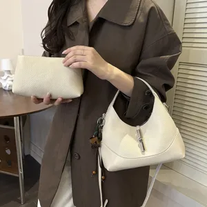 Detailed shot of trendy beige leather hobo shoulder crossbody dumpling bag for women stylish.