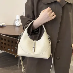 Chic off-white hobo shoulder bag with metal lock, stylish minimalist design for women.