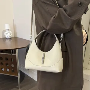 Elegant women's leather shoulder bag with chic metal lock closure for daily fashion style.