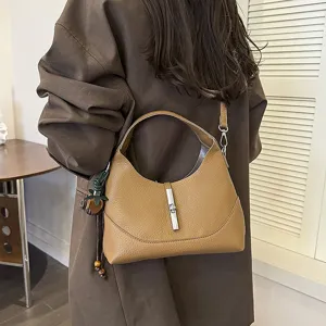 Elegant brown leather hobo shoulder bag for women, vintage dumpling crossbody bag with metal lock.