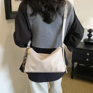 Detailed view of women casual shoulder crossbody bag, soft PU leather hobo bag with strap.