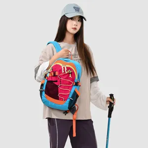 Close-up detail of a colorful outdoor mountaineering backpack worn by model, multi-pocket design.