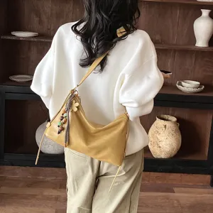 Trendy autumn women shoulder bag, large capacity commuting crossbody bag with chic pendant.