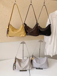 Stylish women shoulder crossbody bag large capacity commuter hobo bag with tassel pendant.