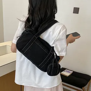 Casual black denim shoulder bag for women, stylish crossbody bag with cute coin purse inside.