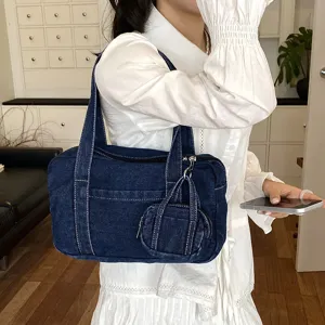 Casual denim shoulder bag with mini pouch charm, stylish daily handbag for women.