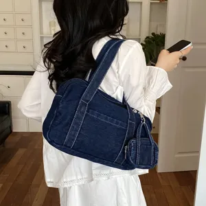 Vintage denim shoulder bag with mini pouch detail, stylish retro casual handbag for women.