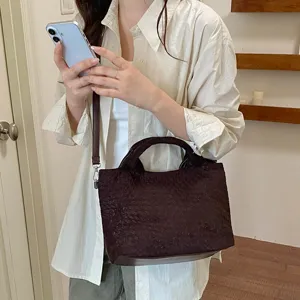 Bolso tote trenzado marrón oscuro en detalle, elegante bolso de cuero para el uso diario.
