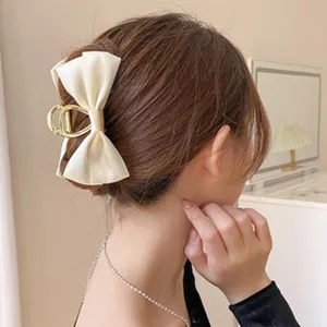 Elegant white satin bow metal hair claw clip for women, stylish back head hair styling tool.