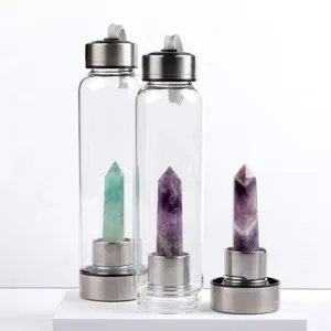 Glass water bottle with natural amethyst and fluorite crystal point inside