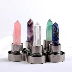 Close-up of various natural crystal obelisks mounted on stainless steel water bottle caps