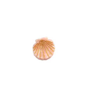 Kleine rosa Haarklammer in Muschelform mit goldenen Akzenten, ideal für die Haare.