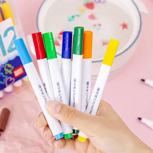 Hand holding colorful water floating pens set of 12 for children creative water painting.