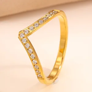 Detailed close-up shot of the geometric V-shaped gold paved diamond ring showcasing sparkling stones.