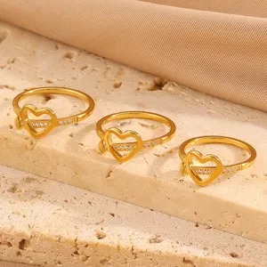 Detailed close-up shot of elegant 18k gold plated stainless steel heart ring with sparkling stones.