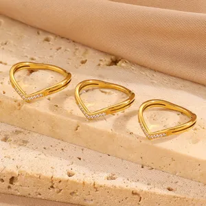 Detail shot of dainty 18K gold plated titanium steel V-shaped heart paved cubic zirconia ring.