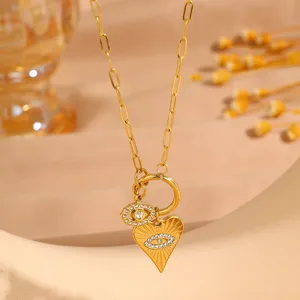 Detailed view of gold stainless steel paperclip chain necklace with evil eye and heart charms.