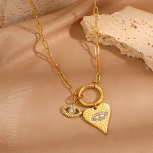 Detail shot of the trendy evil eye heart circle pendant necklace in chic gold titanium steel.