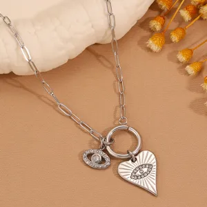 Evil eye heart pendant titanium steel necklace closeup showing exquisite silver link chain details.