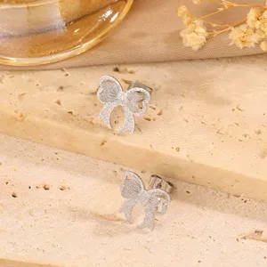 Stainless steel bow stud earrings for women, chic frosted design jewelry for daily wear.