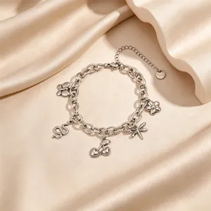 Exquisite multi-element charm bracelet featuring unique shapes, elegant steel design detail.