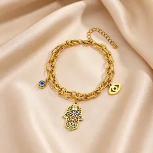 Gold titanium steel Hamsa hand evil eye charm bracelet detail showing intricate patterns.