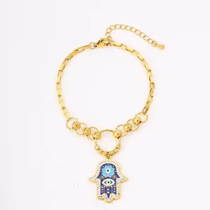 Gold stainless steel Hamsa hand bracelet with blue evil eye pendant for women, chic and stylish.