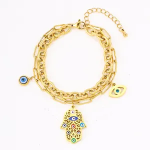Gold stainless steel double layer bracelet with hamsa hand and evil eye charms for women.
