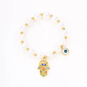 Titanium steel evil eye hamsa hand bracelet detail view, elegant gold jewelry for women.