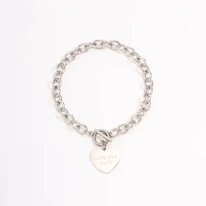 Detail shot of stainless steel chain bracelet with engraved heart pendant and OT toggle clasp.