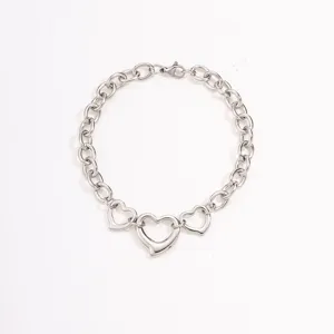 Detailed view of silver stainless steel heart link chain bracelet featuring triple open heart pendants.