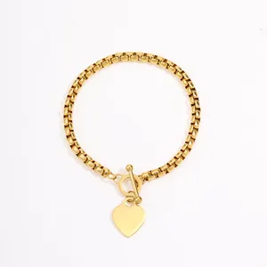 Close-up detail of the gold stainless steel box chain bracelet with heart pendant and toggle.