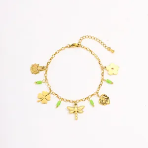 Gold plated stainless steel bracelet detail, featuring cute nature charms and green beads.