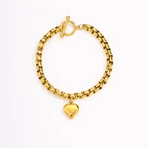 Gold stainless steel heart pendant OT clasp bracelet detail view, elegant minimalist design.
