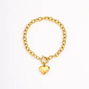 Detailed shot of gold-plated puffy heart pendant bracelet with trendy toggle clasp design.