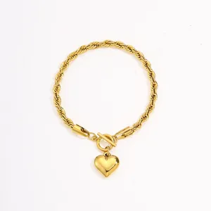 Gold-toned twisted rope chain bracelet featuring a heart pendant and toggle clasp detail.