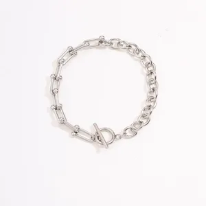 Stainless steel U-link chain bracelet with T-bar clasp, minimalist silver jewelry detail.