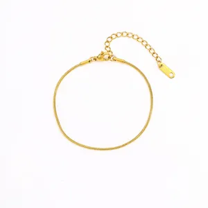 Minimalist golden stainless steel snake chain bracelet detail showing clasp and extension.