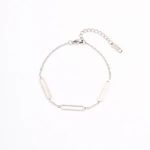Closeup of minimalist silver stainless steel geometric link bracelet with secure lobster clasp.