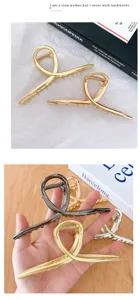 Metallic hair claw clip with stylish cross design, elegant hair accessory for women daily styling.