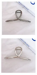 Metallic hair claw clip with stylish cross design for women, elegant daily headwear.