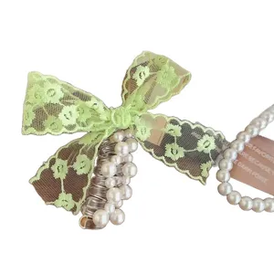 Korean style sweet green lace bow telephone wire hair tie with elegant pearls accessory.