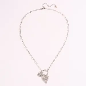 Detail shot of the evil eye heart pendant necklace, titanium steel paperclip chain jewelry.